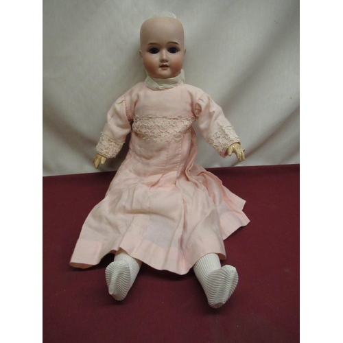 889 - Schoenau & Hoffmeister bisque headed doll marked to neck 1909 4, wearing a pink dress with lace deta... 