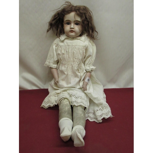 895 - Kestner bisque headed doll marked Dep 10 154 to neck, wearing brown wig and white dress, H64cm