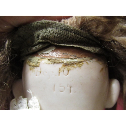 895 - Kestner bisque headed doll marked Dep 10 154 to neck, wearing brown wig and white dress, H64cm