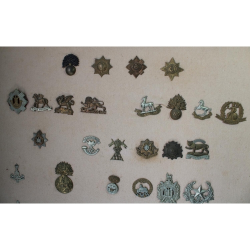 22 - Selection of 59 mounted and framed British Army military cap badges, mainly mid-C20th with a few ear... 