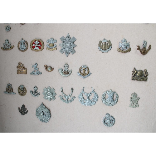 22 - Selection of 59 mounted and framed British Army military cap badges, mainly mid-C20th with a few ear... 