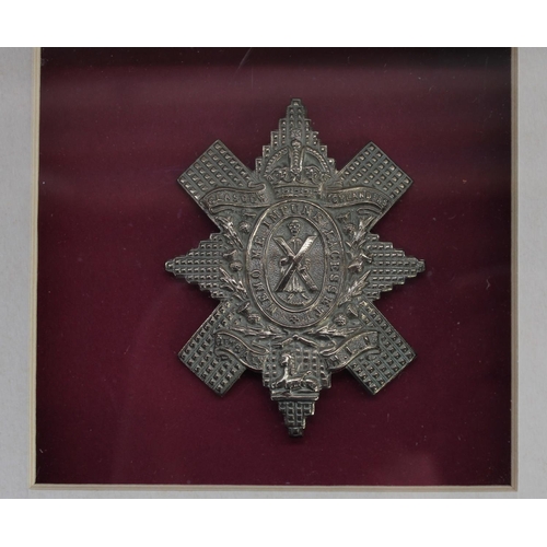 28 - Selection of framed British military regimental cap badges with a few collar badges and shoulder tit... 
