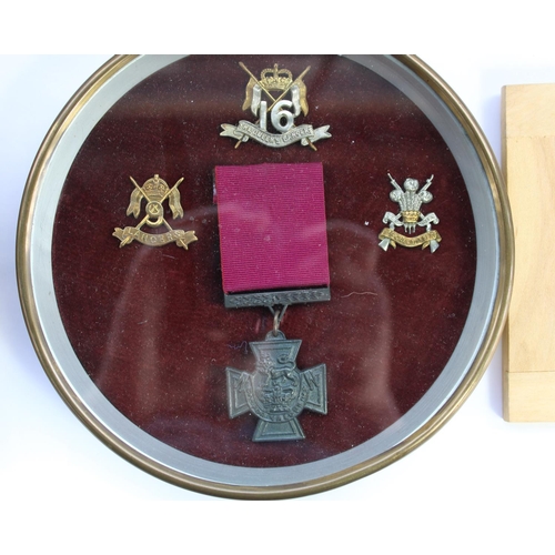 28 - Selection of framed British military regimental cap badges with a few collar badges and shoulder tit... 