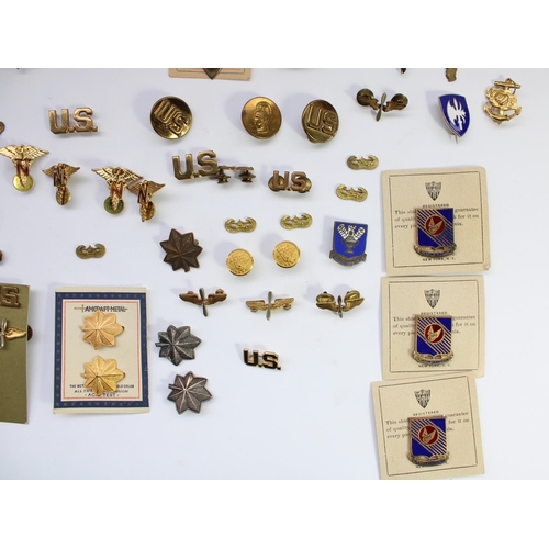 45 - Large selection US military insignia, badges, titles, pips etc. Mostly WW2 era with a small few late... 