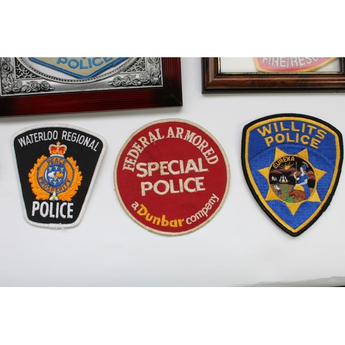 66 - Collection of world police badges and patches including Canadian Mounties, Hong Kong Narcotics Burea... 