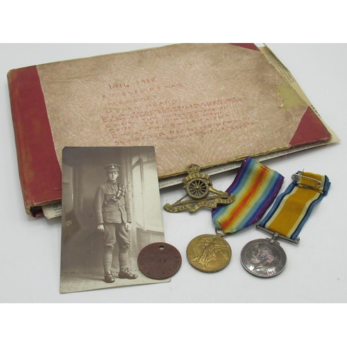 59 - WWI pair awarded to 780589 GNR.E. Heard R. A with associated cap badge and service tag, photographic... 