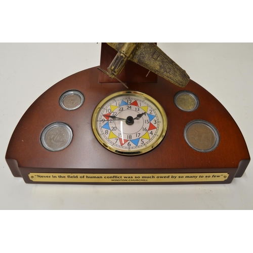 471 - Danbury mint commemorative Battle of Britian clock with painted resin Spitfire and Bf109, four perio... 