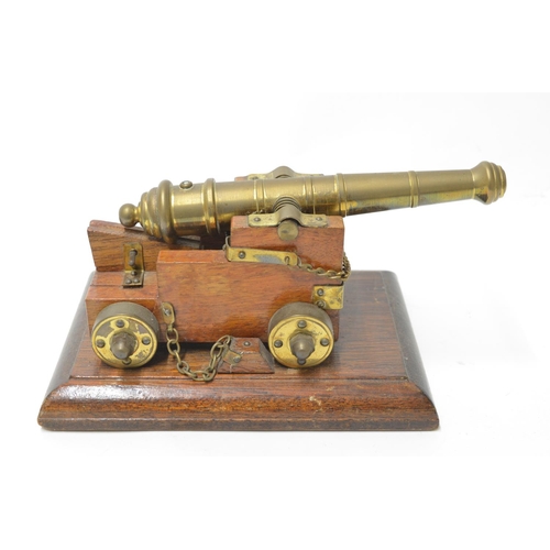 472 - Model naval canon, wood and brass (non functioning, no firearms licence required to own) and a naval... 