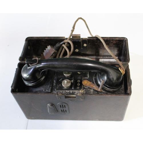 200 - Field telephone in Bakelite with German phonetic alphabet stamped with swastika and eagle, and Bakel... 