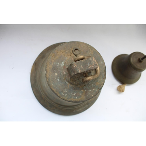 443 - C19th Solid bronze cast bell (very heavy) H30cm, together with a smaller early C20th cast metal bell