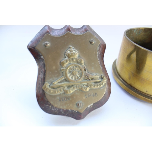 77 - Two brass ashtrays formed from shell case bases, one with Royal Artillery crest, a Royal Artillery s... 