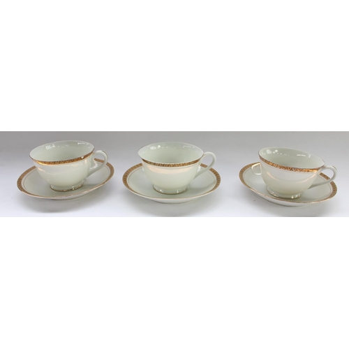 81 - Set of three German Third Reich era porcelain cups and saucers with gilt and black Swastika design b... 