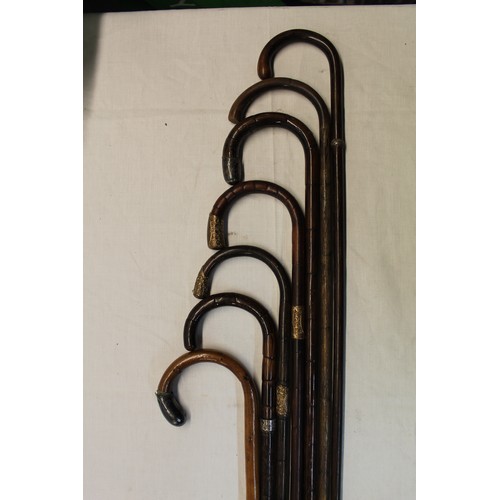 400 - Set of seven walking canes four with metal mounted handles and metal collars
