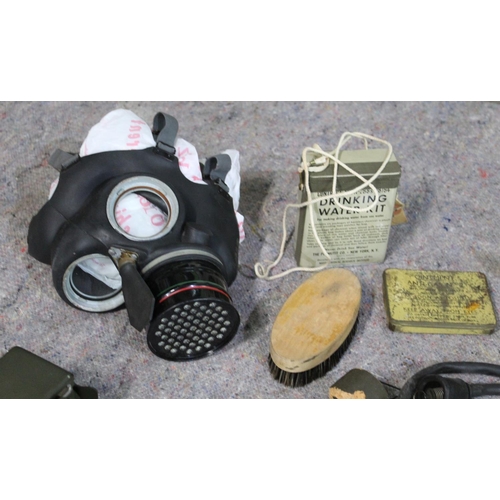 335 - WWII military related items, including gas mask, water purifier, tin containing drinking water kit, ... 