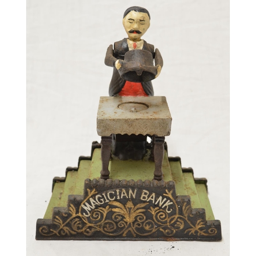 510 - Vintage metal Magician coin bank, written to the base 