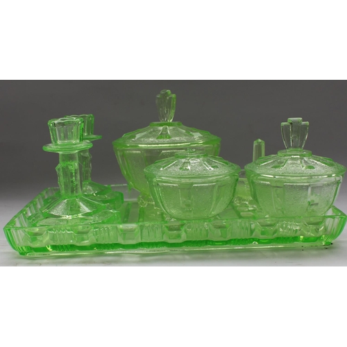 281 - Art Deco bedroom set in green glass comprising tray, candlesticks, pin tray, and lidded jars