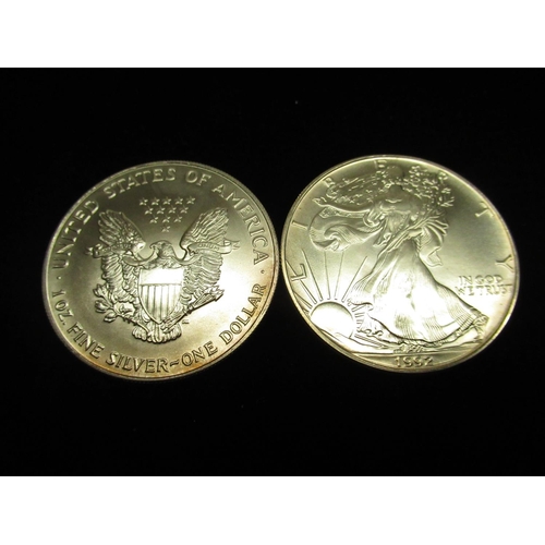 524 - Two United States of America 1oz fine silver one dollar coins, in plastic sleeve