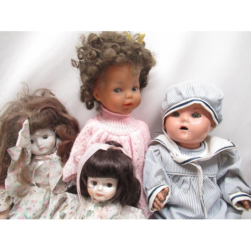 395 - Early to mid C20th papier mache doll together with six modern porcelain dolls and one other plastic ... 
