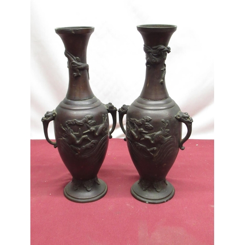 295 - Pair of Meiji period bronze vases of baluster form, with dragon mask handles, raised detail of flyin... 