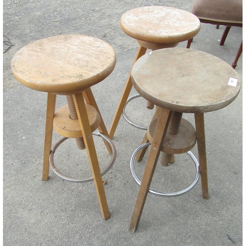551 - Set of three Ikea kitchen stools with circular adjustable tops and chrome plated footrests on three ... 