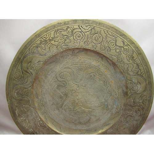 227 - C20th Chinese brass charger with engraved dragon to centre surrounded by a Greek key border the oute... 