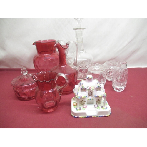 310 - Large Cranberry glass jug, two smaller cranberry glass jugs both with shaped rim and a cranberry gla... 