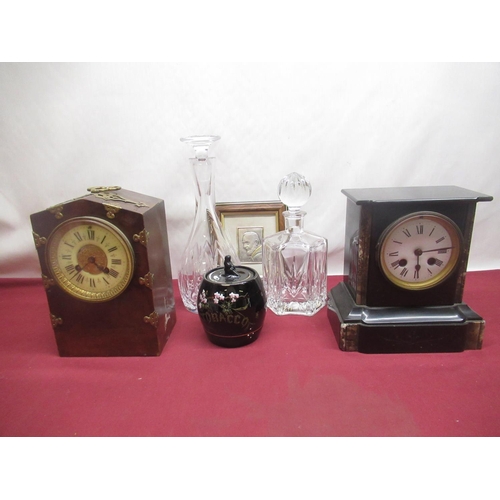 317 - Two glass decanters and two wooden cased mantle clocks