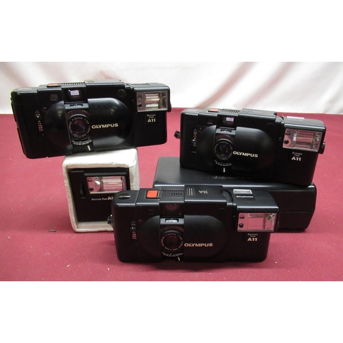 150 - Three Olympus XA Rangefinder cameras including flash guns