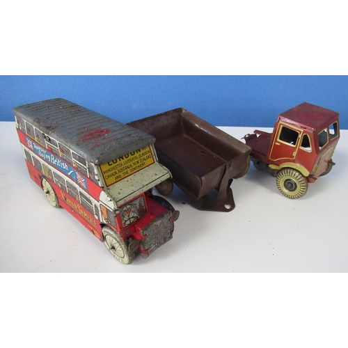 581 - Wells World Service tinplate clockwork double decker bus , a tinplate lorry cab and a tinplate tippi... 