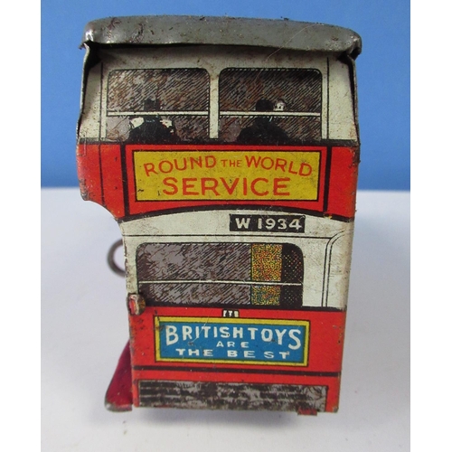 581 - Wells World Service tinplate clockwork double decker bus , a tinplate lorry cab and a tinplate tippi... 