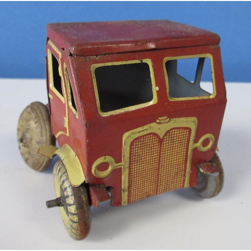 581 - Wells World Service tinplate clockwork double decker bus , a tinplate lorry cab and a tinplate tippi... 