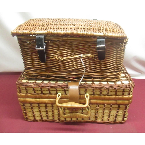 409 - Wicker picnic basket with checked interior, a set of four plastic plates, mugs and cutlery and anoth... 