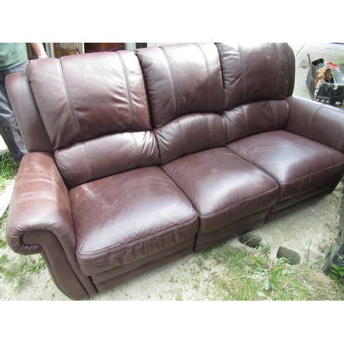 650 - Brown leather three piece suite comprising: three reclining seat and two reclining seat sofas and an... 