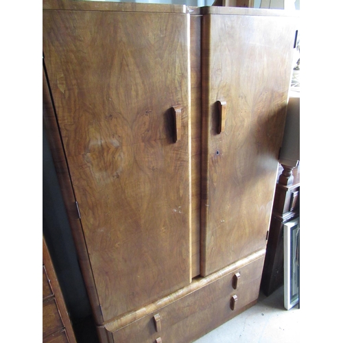 659 - Art Deco figured walnut gentlemen's wardrobe, with two doors and part fitted interior above two draw... 