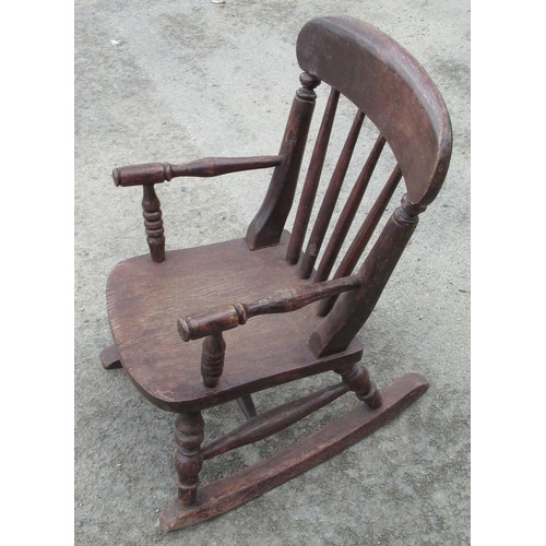 686 - Child's stained beech Windsor type rocking chair with stick back and turned supports