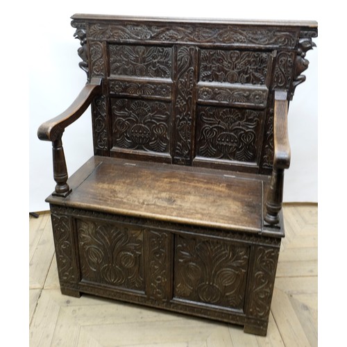 1455 - C20th oak settle, raised scroll work back with four earlier carved and initialled panels, moulded do... 