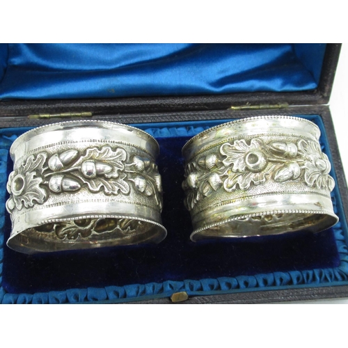 1191 - Pair of Victorian hallmarked Sterling silver napkin rings, repoussé decorated with acorns and oak le... 
