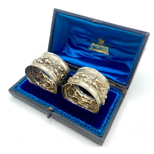 1191 - Pair of Victorian hallmarked Sterling silver napkin rings, repoussé decorated with acorns and oak le... 
