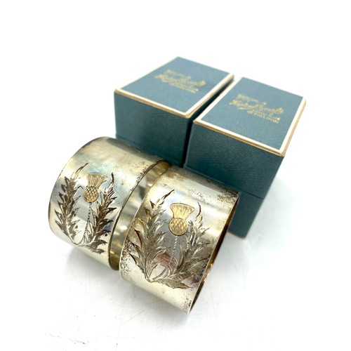 1193 - Pair of ERII hallmarked sterling silver napkin rings with bright cut gilt thistle, by Charles S Gree... 