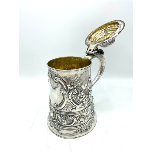 1155 - Geo.III hallmarked sterling silver lidded tankard, probably later engraved and repousse with flowers... 