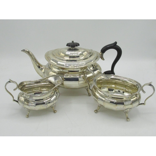 1152 - Geo.V hallmarked sterling silver three piece tea service, tea pot with ebonised handle and final, se... 