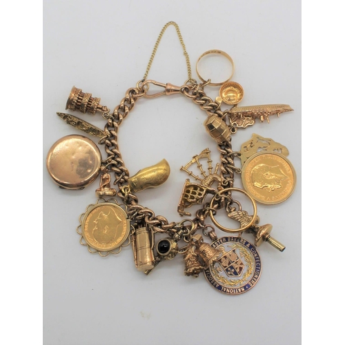 1111 - Hallmarked 9ct yellow gold charm bracelet Chester, 1902, with a collection of charms including Geo.V... 