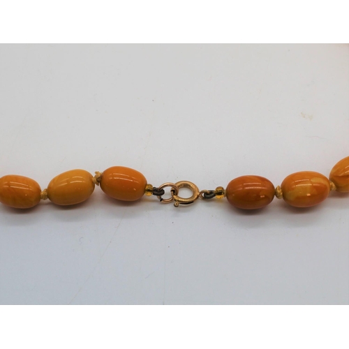 1124 - Butterscotch amber necklace, single row of graduated oval beads, largest approx. 2.5cm, overall leng... 