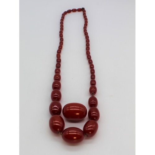 1123 - Cherry amber necklace, single row of graduated oval Cherry amber beads, largest approx. 3cm, overall... 