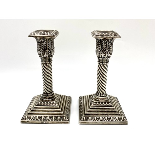 1163 - Pair of small Edw.VII hallmarked sterling silver candlesticks, lobed acanthus sconces on wrythen col... 