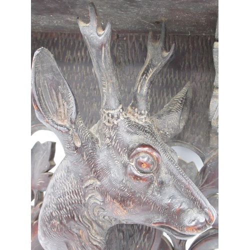 1223 - C19th Black Forest carved wooden wall bracket, moulded shaped top on stag head support, H40cm W34cm