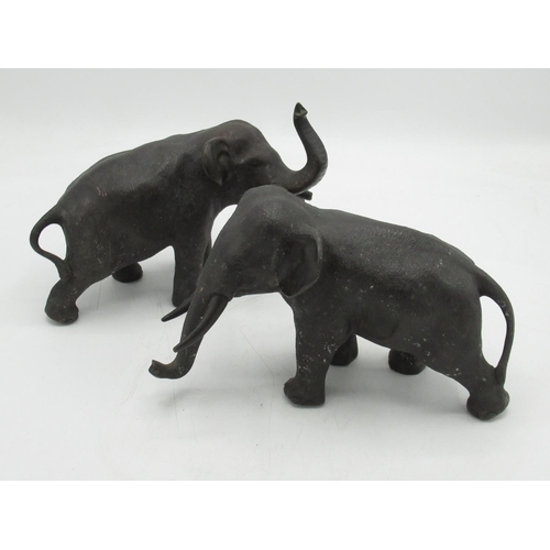 1222 - Pair of small Japanese hollow patinated bronze models of elephants with bronze tusks, both standing,... 