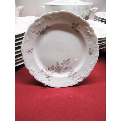 1246 - Comprehensive Continental dinner service relief moulded and printed with sprays of flowers on a whit... 