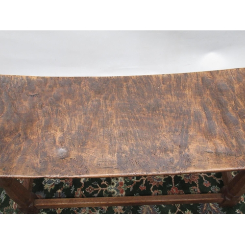 1413 - Robert Mouseman Thompson of Kilburn- an oak rectangular long stool, dished adzed top on octagonal ba... 