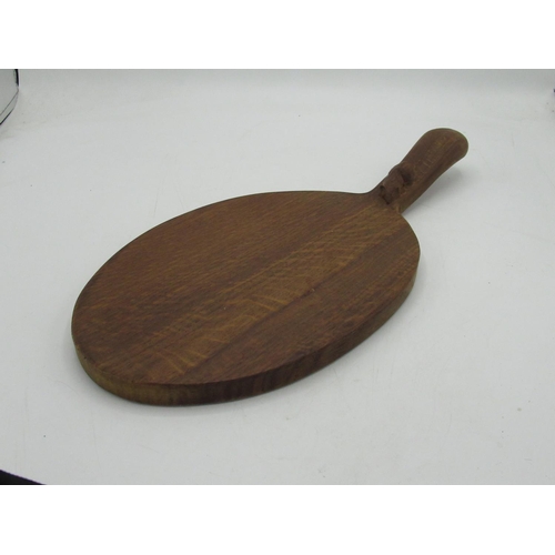 1428 - Robert Mouseman Thompson of Kilburn - an oak oval cheese board, curved handle carved with signature ... 